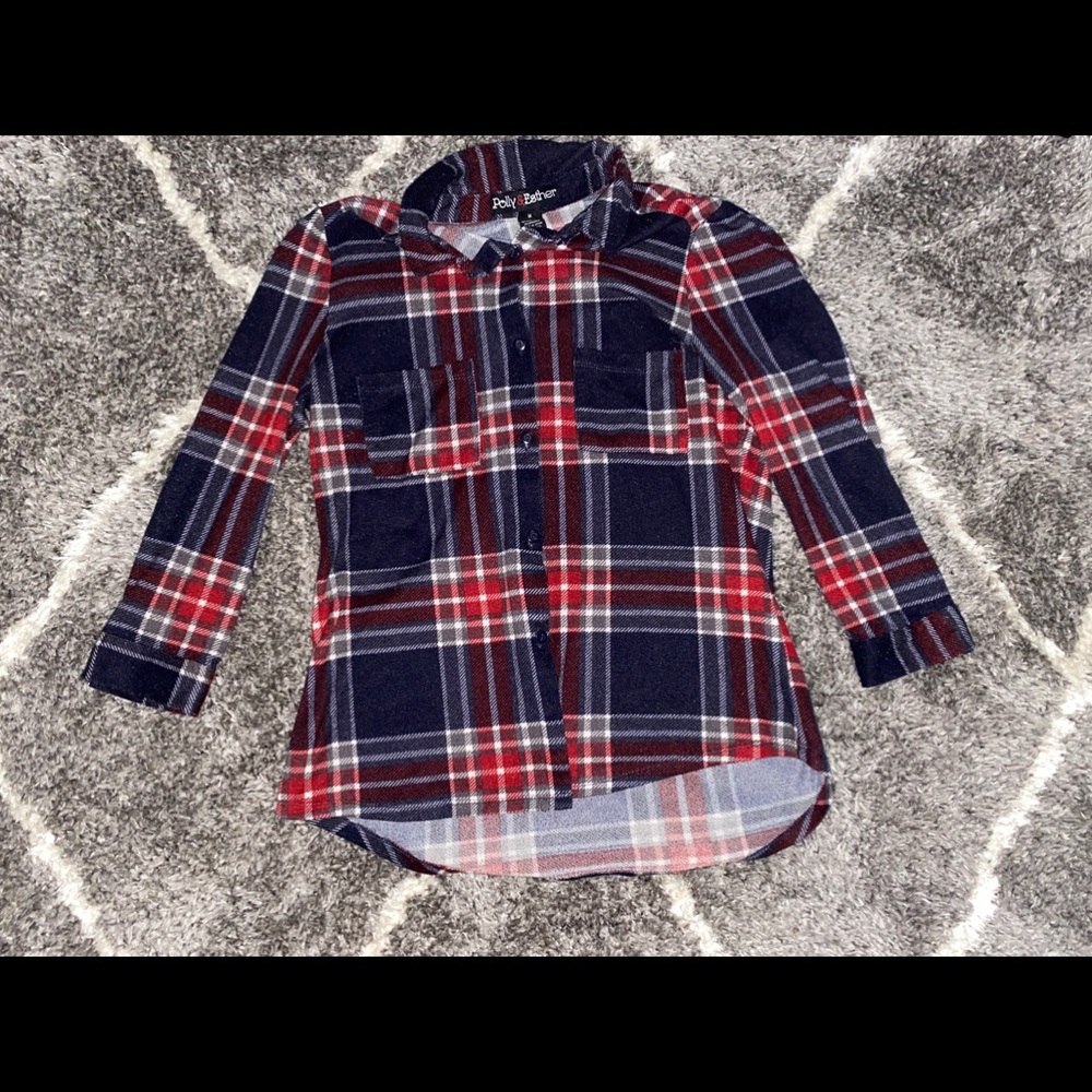 A courter sleeved red, blue, and white flannel